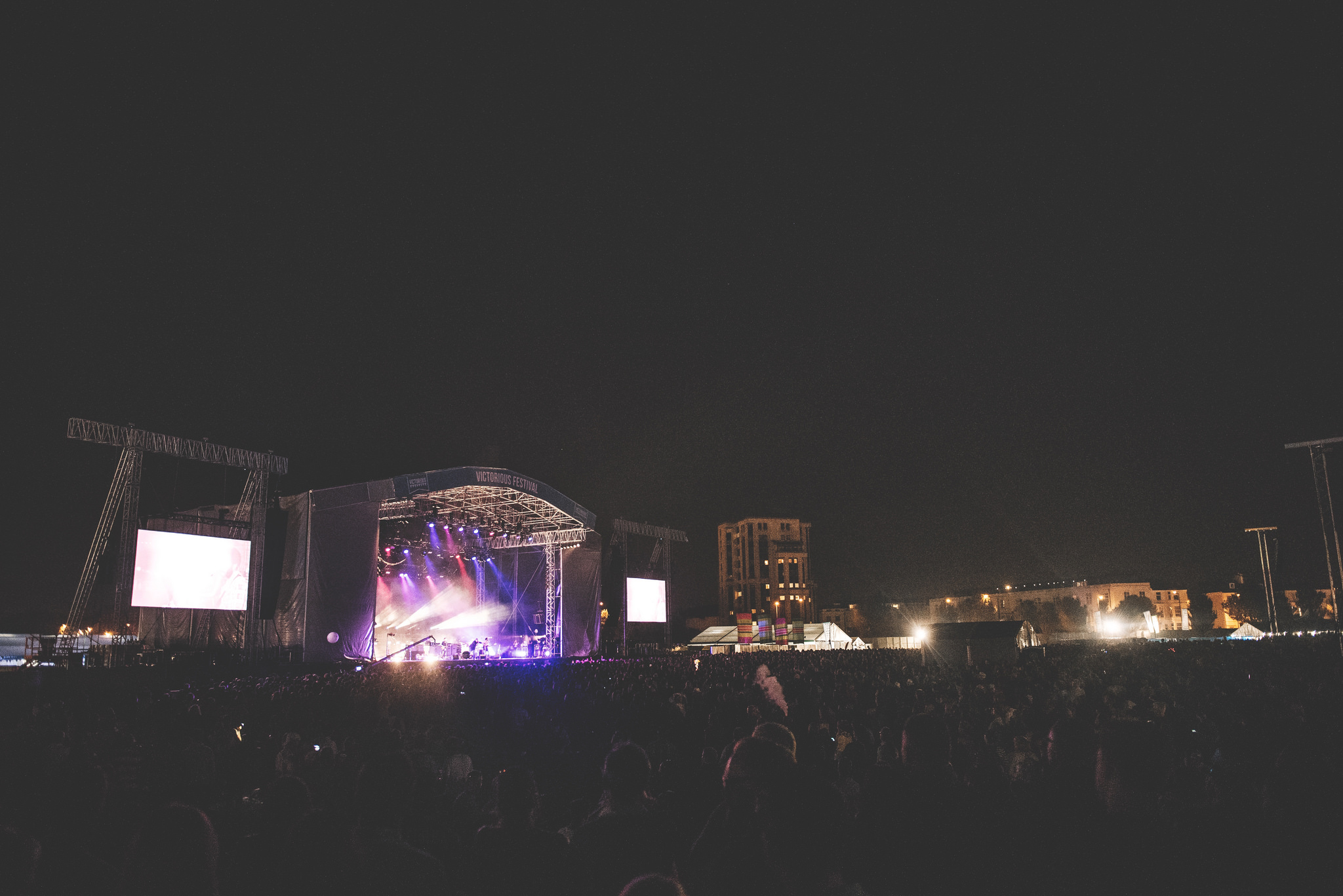 The Victorious Festival Main Stage lit up at night.