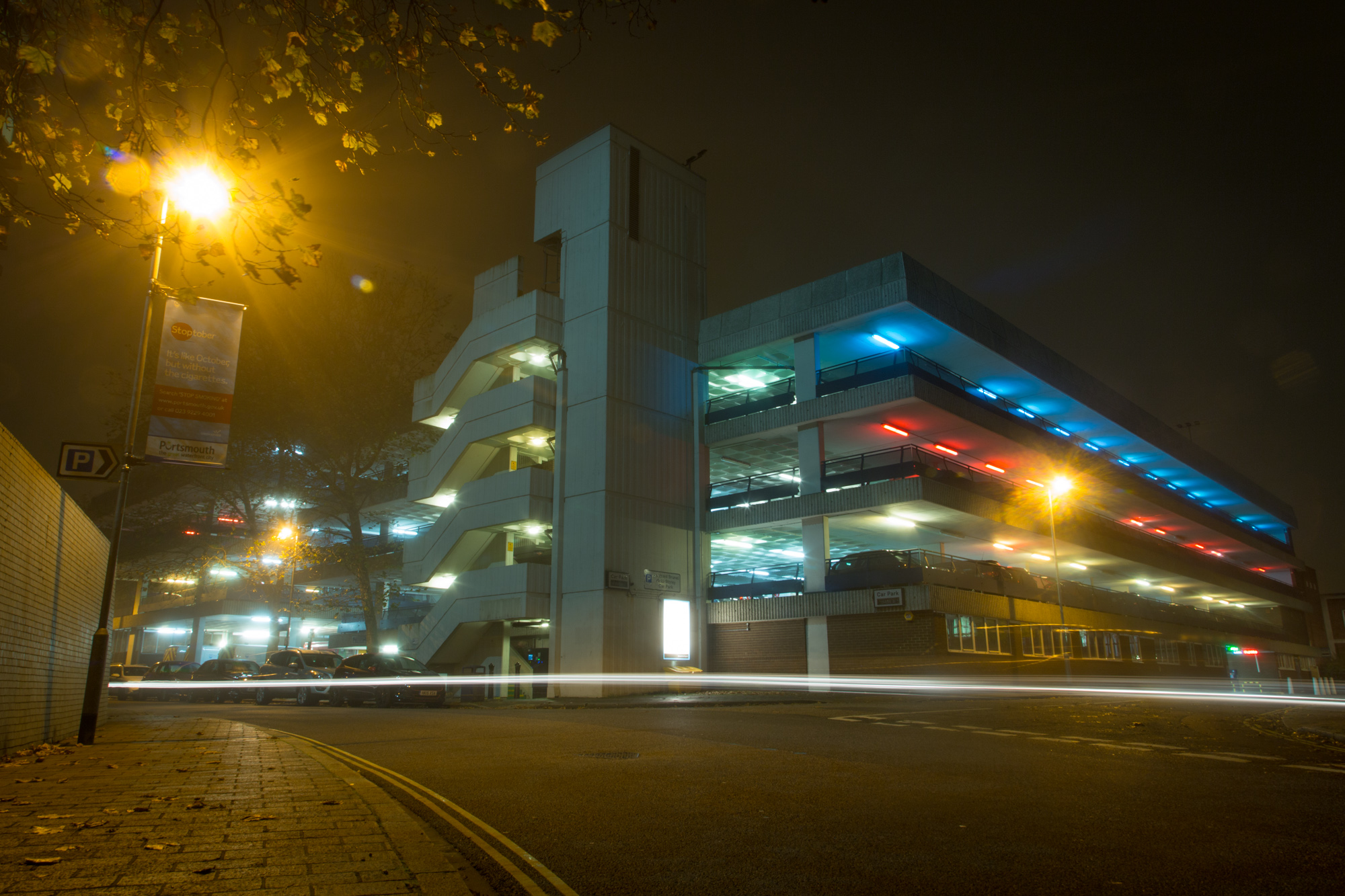 City carpark at night lit up with coloured lights