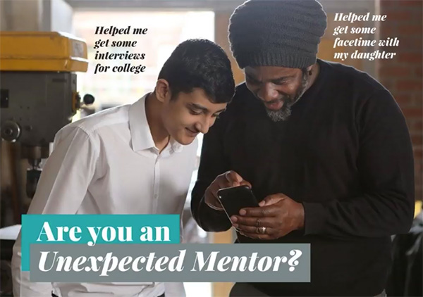 A school student and a mentor are looking at interesting information on a mobile phone