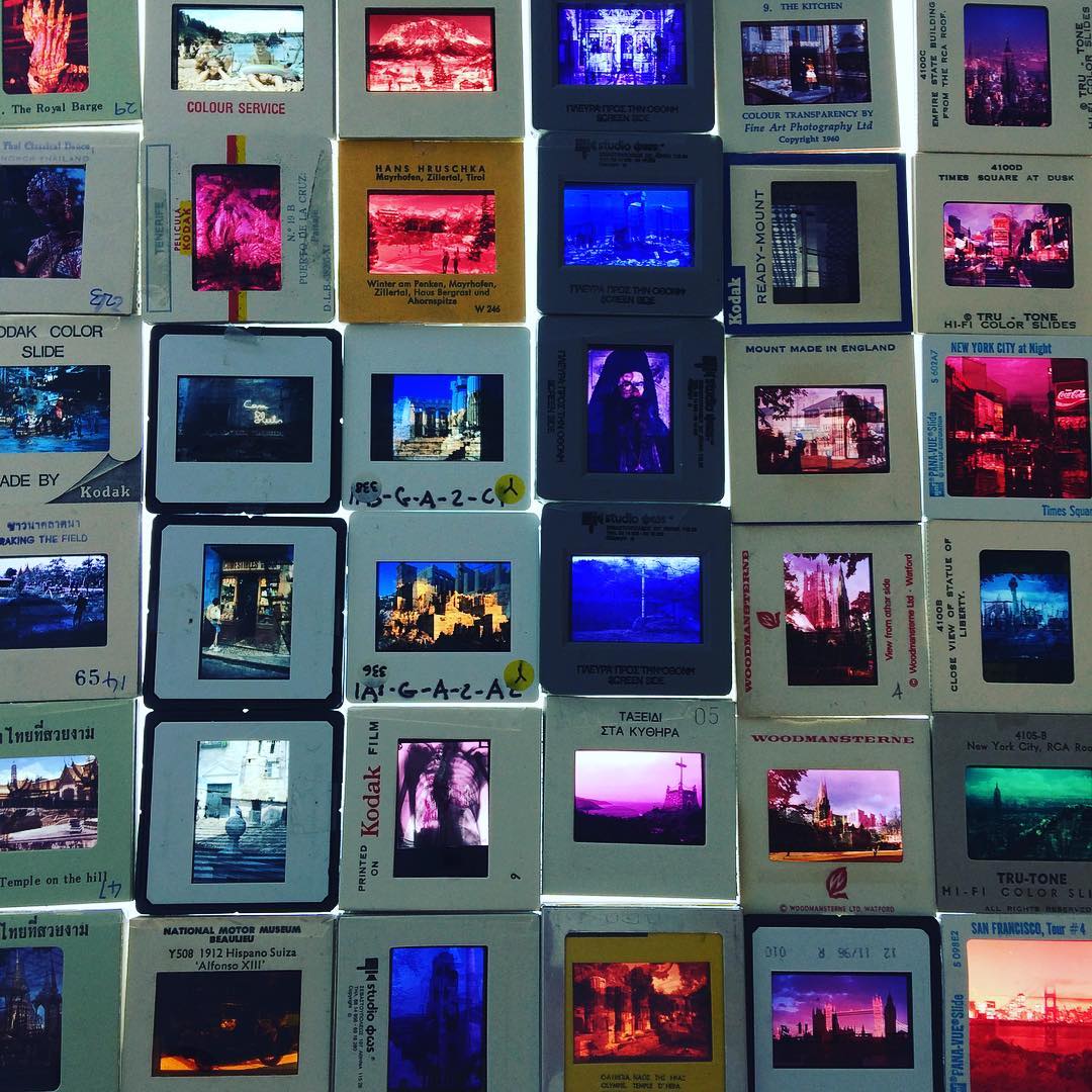 An array of colourful film slides of different views, locations, etc