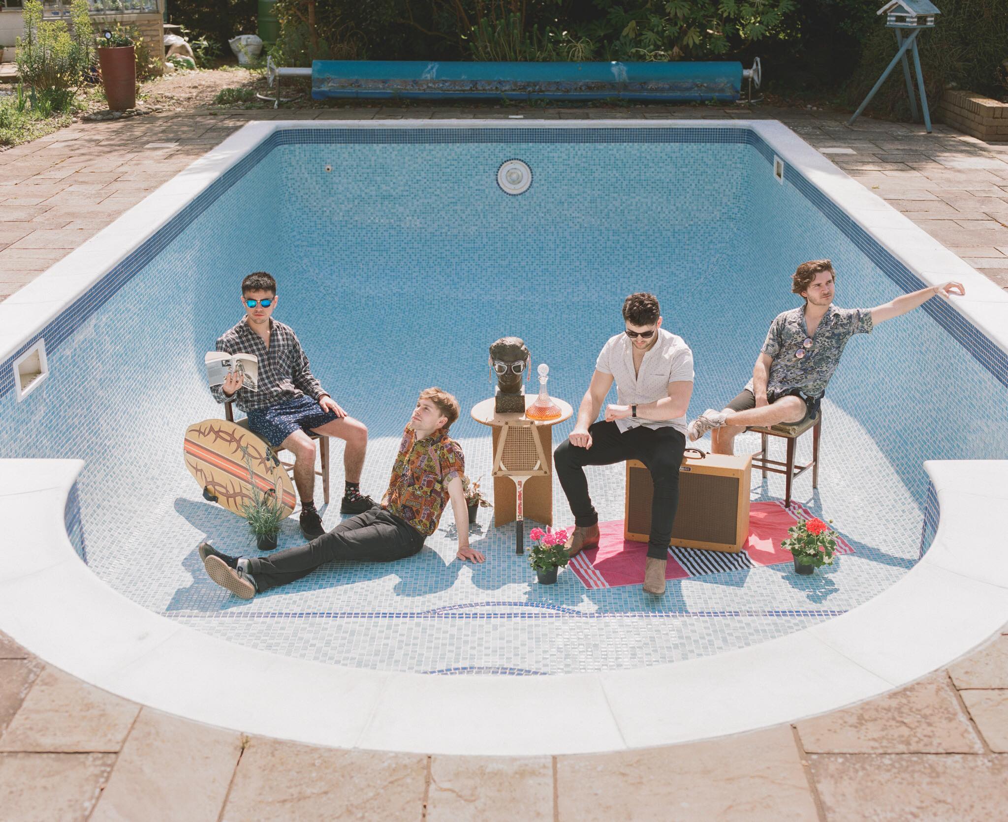 The Dutch Criminal Record band sat in an empty swimming pool with their instruments. Taken by Adam Prosser