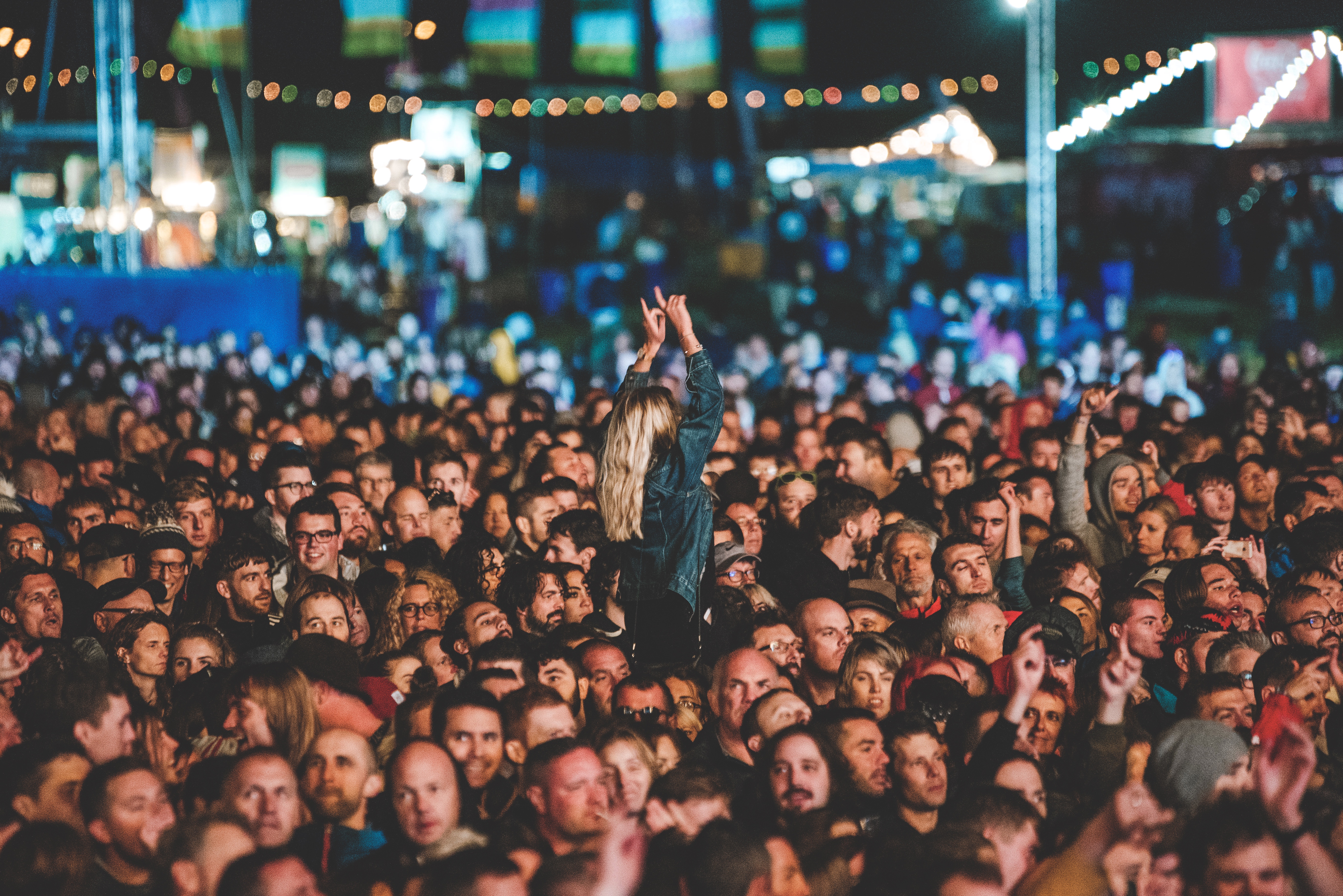 A young girl is held up on someone shoulders while they enjoy the band on the Common stage at Victorious Festival 2018.