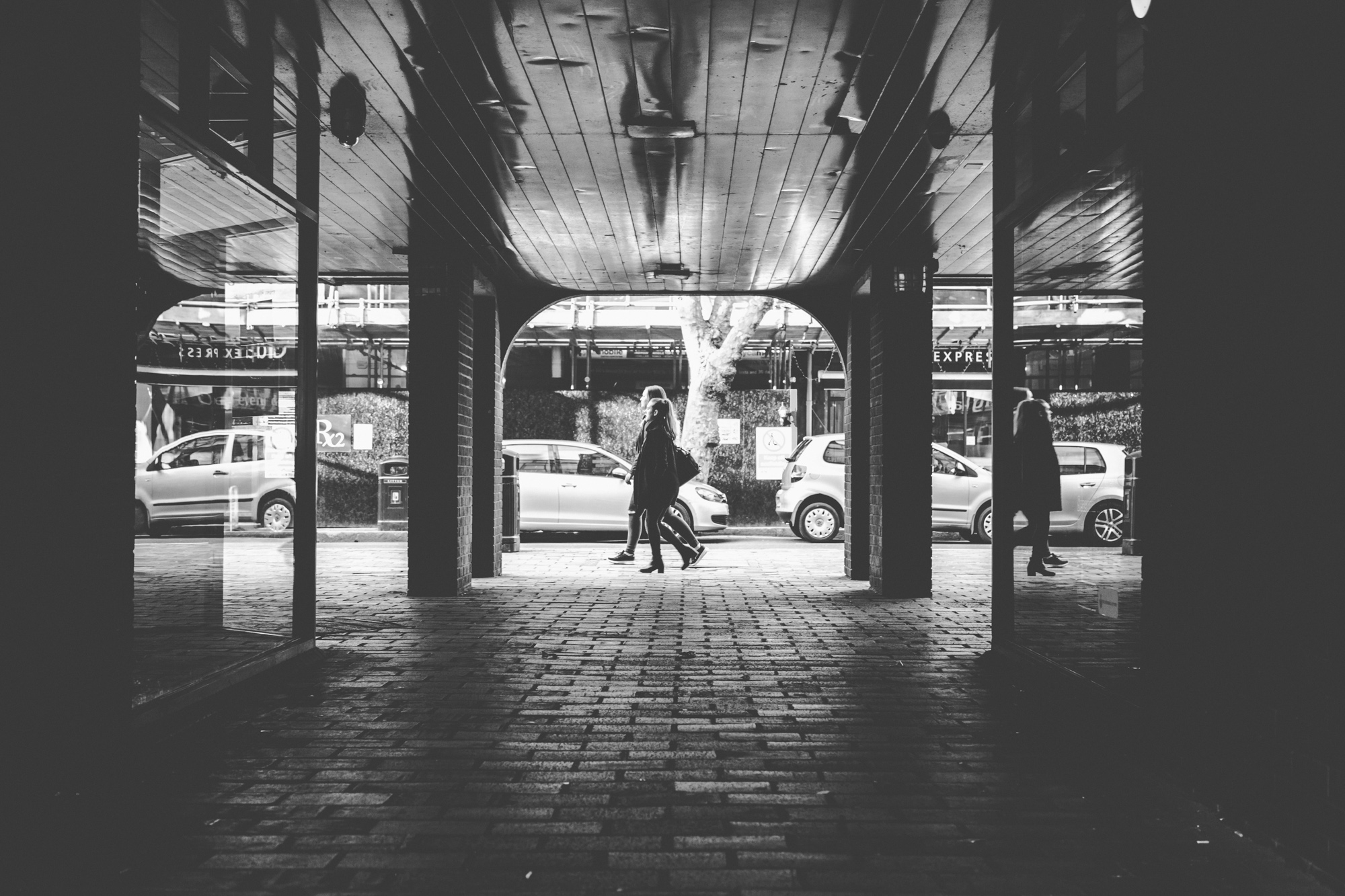 People walk past the entrance of a tunnel on the Portsmouth city streets