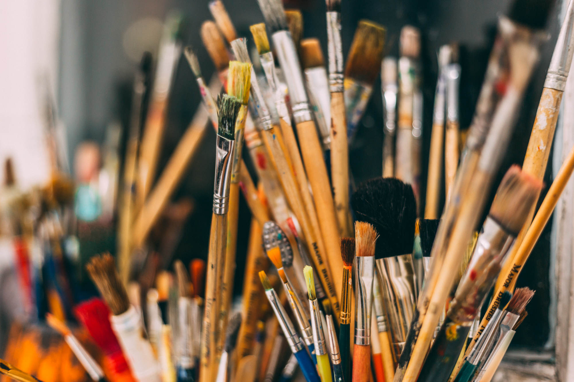 Pots of different artist's paintbrushes