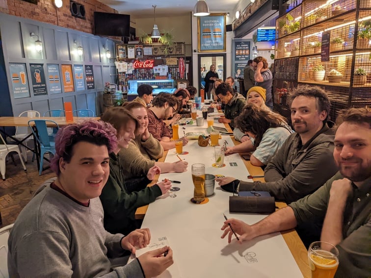 People happily enjoying doodling at a Doodle Quest event